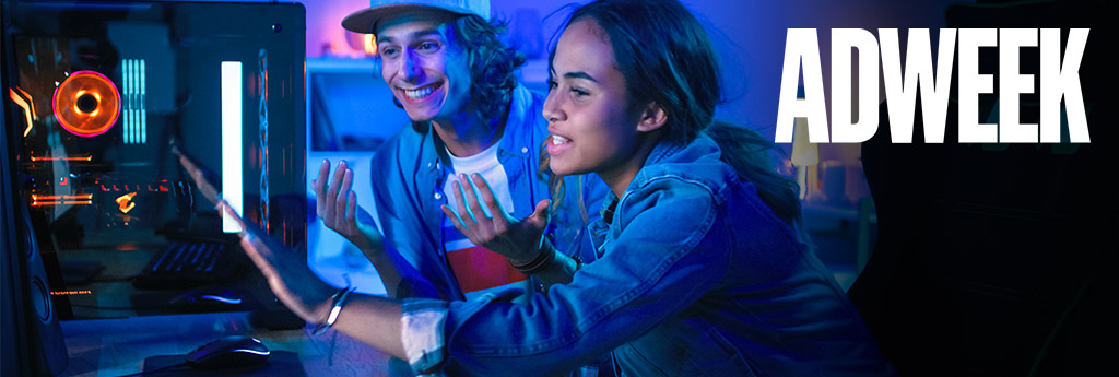 Gen Z girl and boy looking at and interacting with a computer screen with Adweek logo in the top right corner