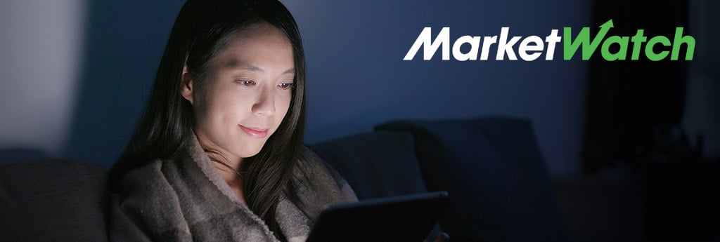Gen Z woman looking at laptop with MarketWatch logo in top right corner of image