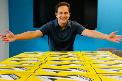 Jason Dorsey standing near many of his Zconomy books